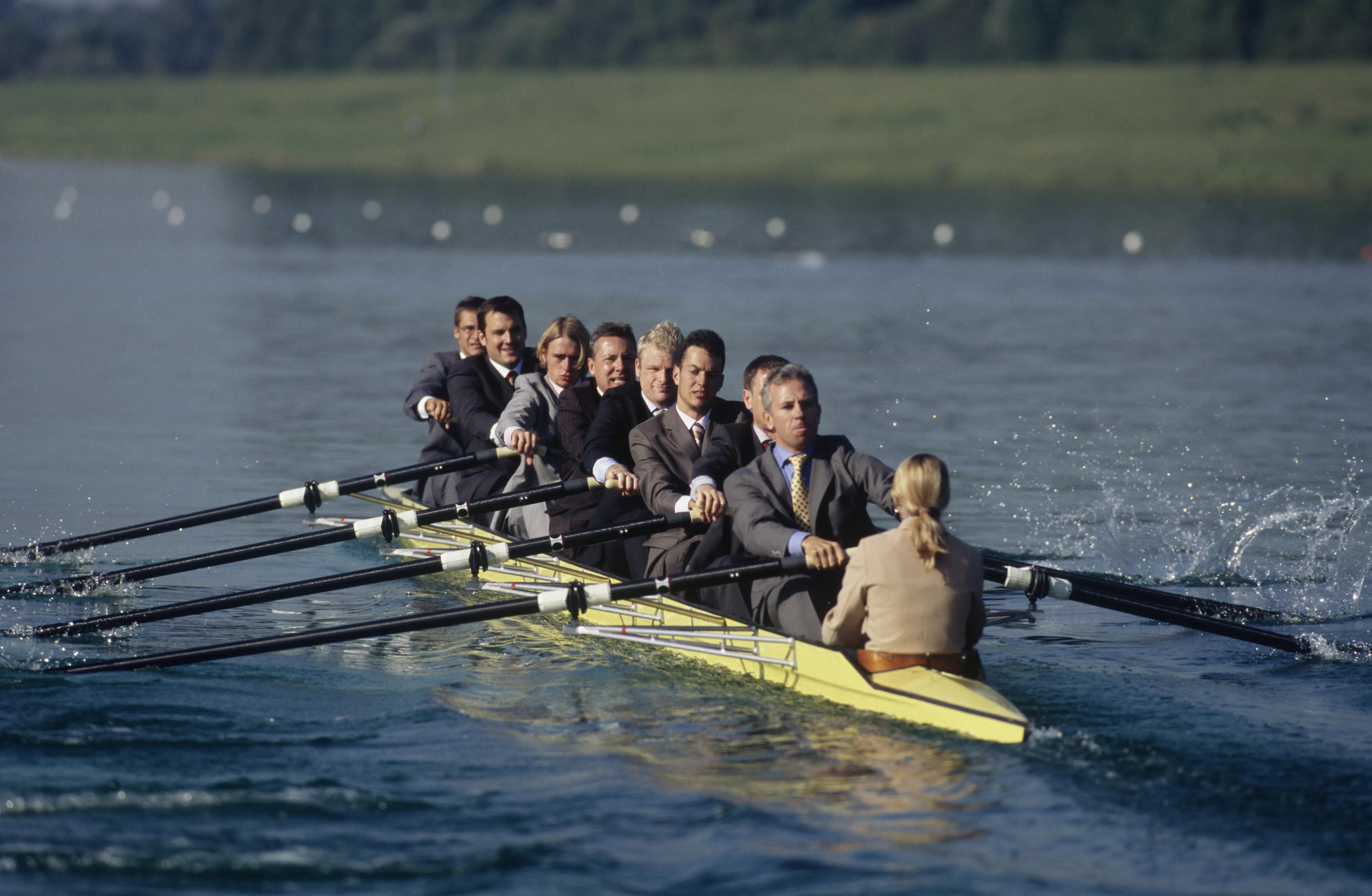 Business team rowing together